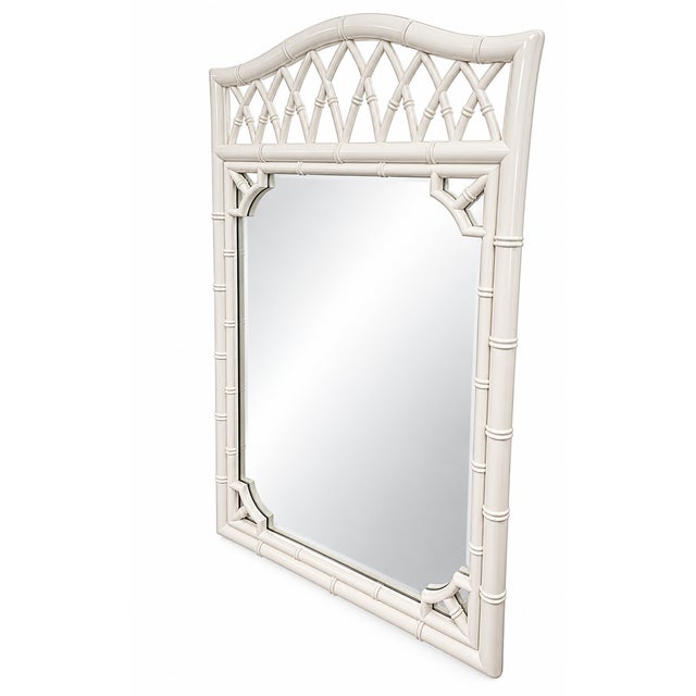 Elegant vintage Chinoiserie-style mirror featuring a beautifully detailed faux bamboo frame with a graceful arched crest,...