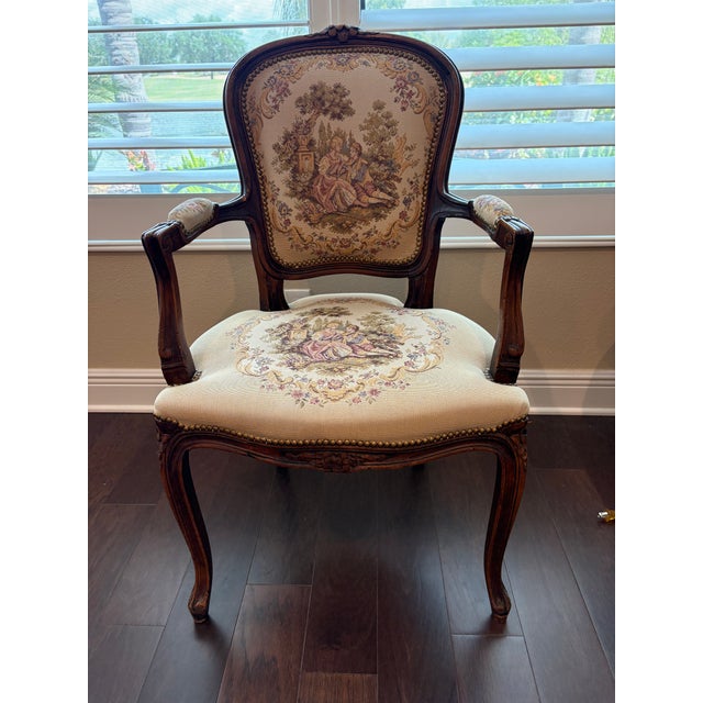 A handsome French Louis XV style fauteuil (open armchair) with a hand-carved walnut-toned hardwood frame and original...