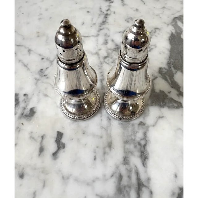 Lovely weighted bottom vintage salt and pepper shakers by Raimond Silver Manufacturing Co. With glass inserts. Stamped....