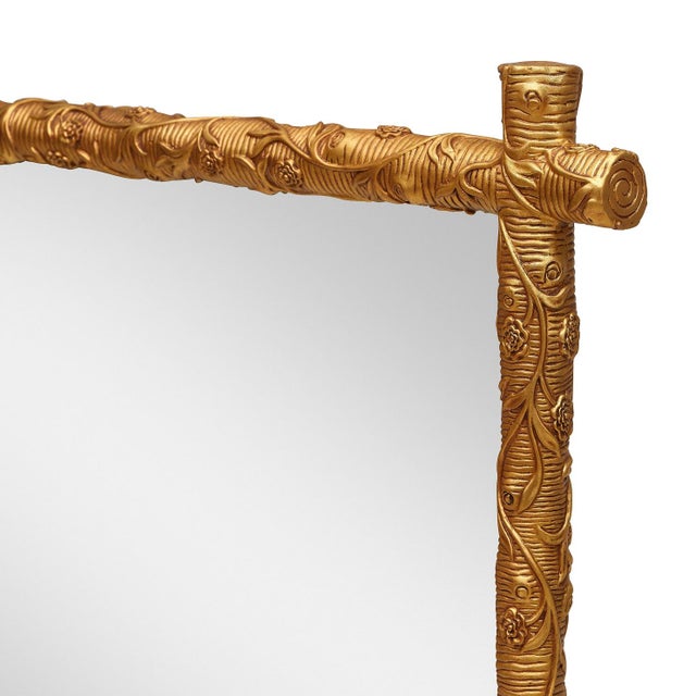 Gilded branches, gnarled and flowering, frame the Tivoli Mirror in a way that feels equal parts garden folly and grand...