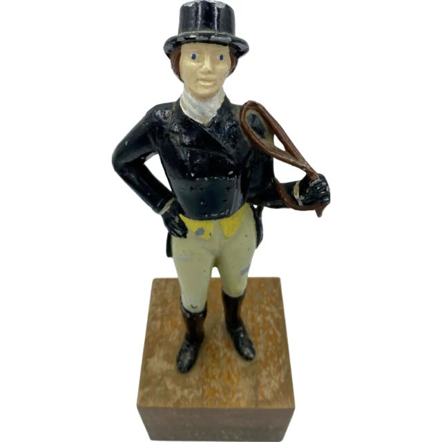 A wonderfully uncommon piece of equestrian décor. Dressed in classic riding attire—a black hunt coat and hat, cream...