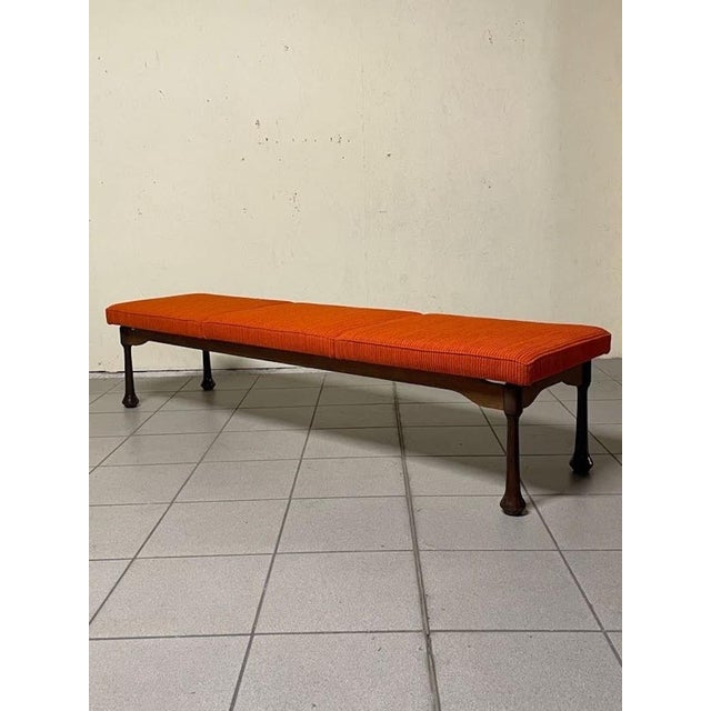 A 1960s bench with a long, elegant seat, made in Italy. Stained wood frame with turned legs and onion-shaped feet. The...