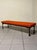 A 1960s bench with a long, elegant seat, made in Italy. Stained wood frame with turned legs and onion-shaped feet. The...