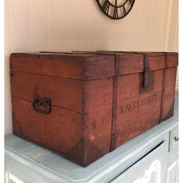 A lovely antique pine immigrant's trunk retaining original red stained finish and original handles, closure and iron...