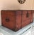 A lovely antique pine immigrant's trunk retaining original red stained finish and original handles, closure and iron...