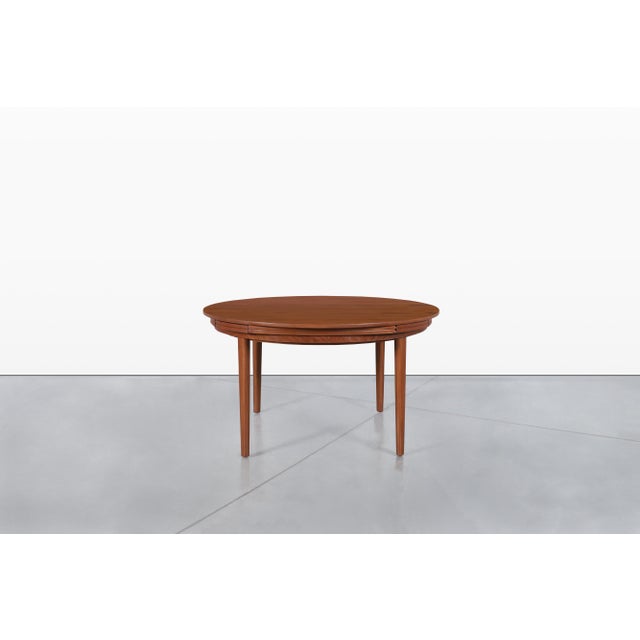 This exceptional mid-century modern dining table, crafted by Dyrlund in Denmark during the 1960s, is a masterclass in both...