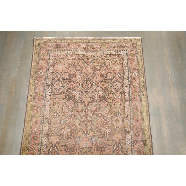 An early 20th-century Persian Malayer rug in predominantly a rustic brown color