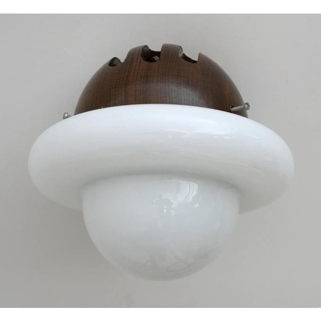 Pair of Italian design wall lamps, built in the 1960s. Fascinating with its rare round opal glass shape. The body of the...