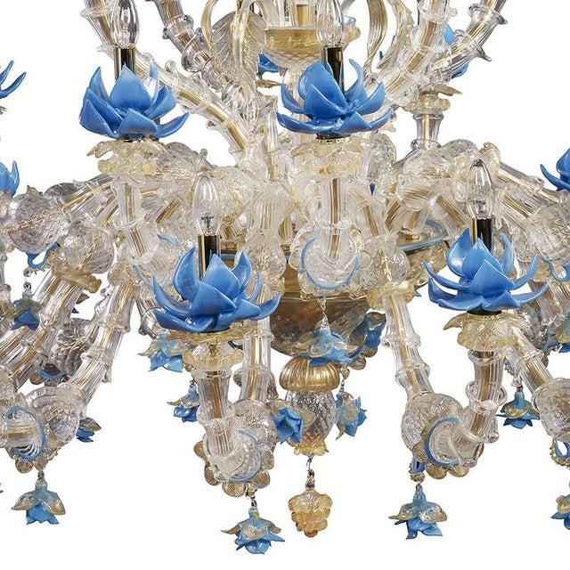 Chandelier in transparent, white and gold Murano glass, forged with ancient lace workmanship and details in gold and blue...