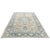 An elegant antique rug featuring a classic Heriz-inspired design in a beautifully softened palette of light beige and...