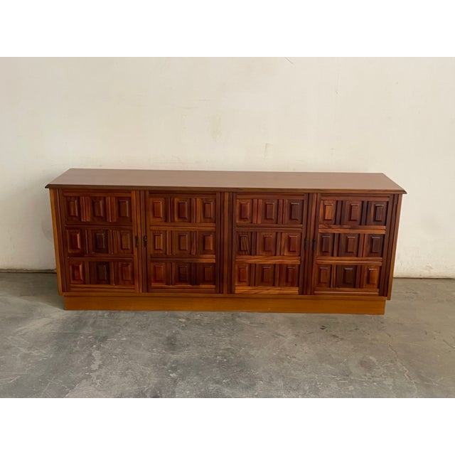 A striking piece of Spanish brutalist design from the 1960s, this walnut sideboard features bold geometric forms and...