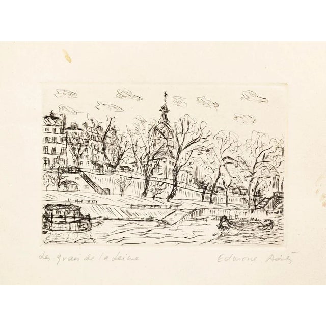 Image dimensions: 9.8 x 14.4 cm. Les Quais de la Seine is a black and white print realized by Edmone A. Ades in the First...