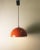 Chandelier in half-sphere of orange lacquered metal, white interior, typical of the 70s. In perfect condition. European...