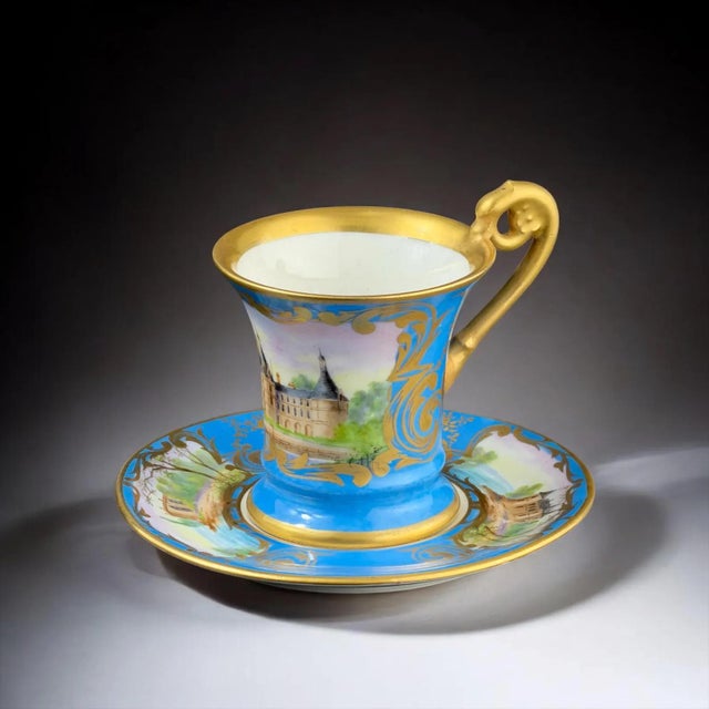 Elegant 19th century French porcelain cup and saucer, executed in the refined Sèvres style, featuring a hand-painted view...