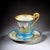 Elegant 19th century French porcelain cup and saucer, executed in the refined Sèvres style, featuring a hand-painted view...