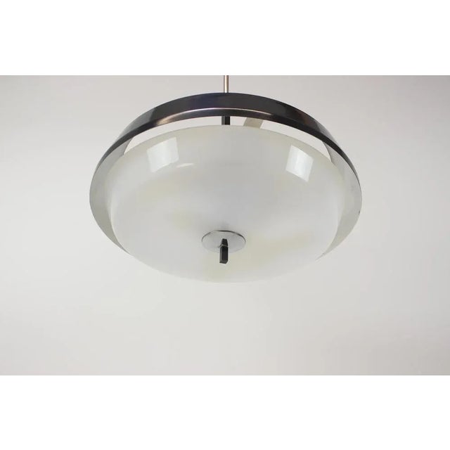 Made in czechoslovakia made of pastic, lacquered metal. 3x 40w, e25-e27 bulbs. Us wiring compatible. This piece is...