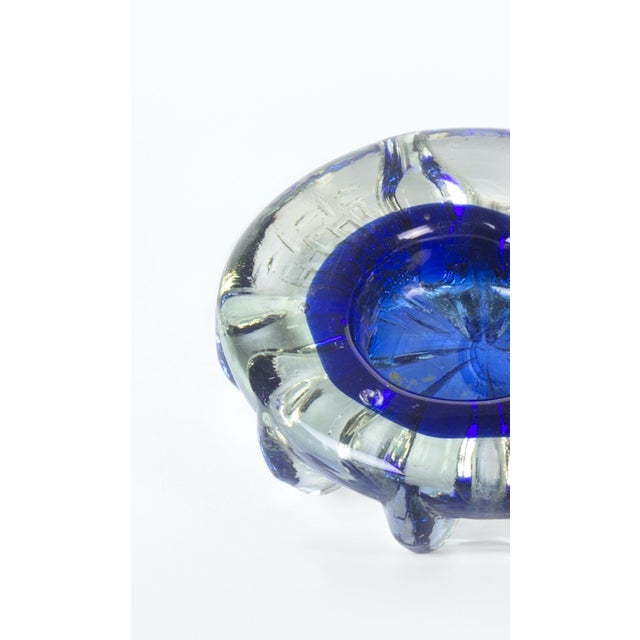 Vintage cobalt blue ashtray is an elegant glass decorative object, realized during the 1970s. Vibrant cobalt blue ashtray...