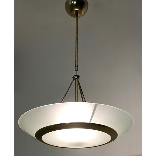 Made in Italy, 1980s. This pendant light is made in brass and aquamarine etched glass. It is a vintage item, therefore it...