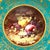 A central circular medallion painted with an arrangement of orchard fruit on a mossy, earth bank anchors this decorative...