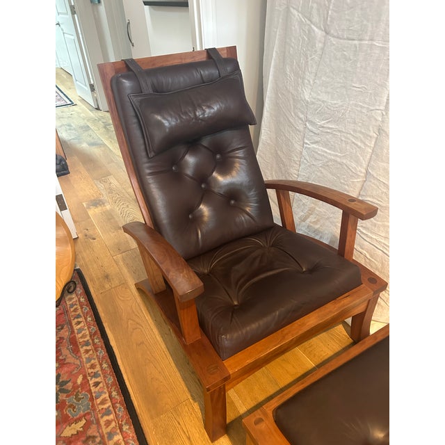A beautifully crafted lounge chair and matching ottoman in the style of Thomas Moser Cabinetmakers, showcasing the...