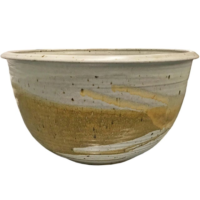 A monumental-scale mid-20th century American studio hand-thrown glazed ceramic bowl with fantastic texture and earthy...