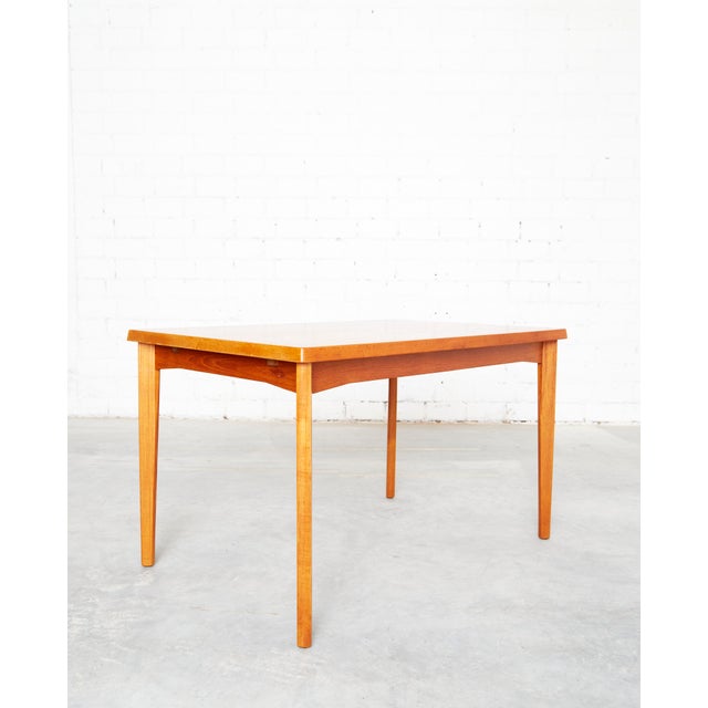 This mid-century modern Teakdining table was designed in the 1960s by Henning Kjaernulf for Velje. It comes with two...