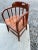 This is an antique oak captain's chair. Exceptionally sturdy, the classic Windsor style chair has a spindle back with wood...