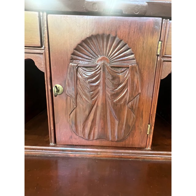 This slant-front desk reflects the Chippendale style that originated in mid-18th century England, named after renowned...