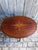 A charming antique oval side table crafted in mahogany, featuring an exquisite hand-inlaid satinwood floral marquetry...