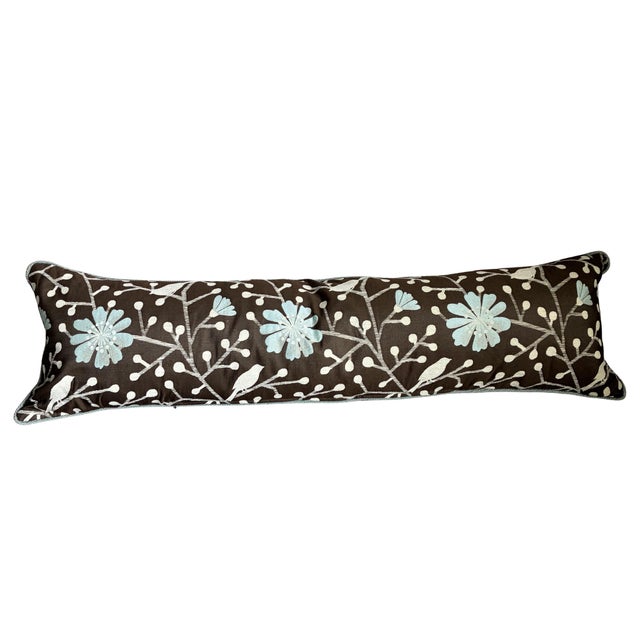 Elegant long lumbar accent pillow featuring a sophisticated botanical and bird motif in soft pale blue and ivory against a...