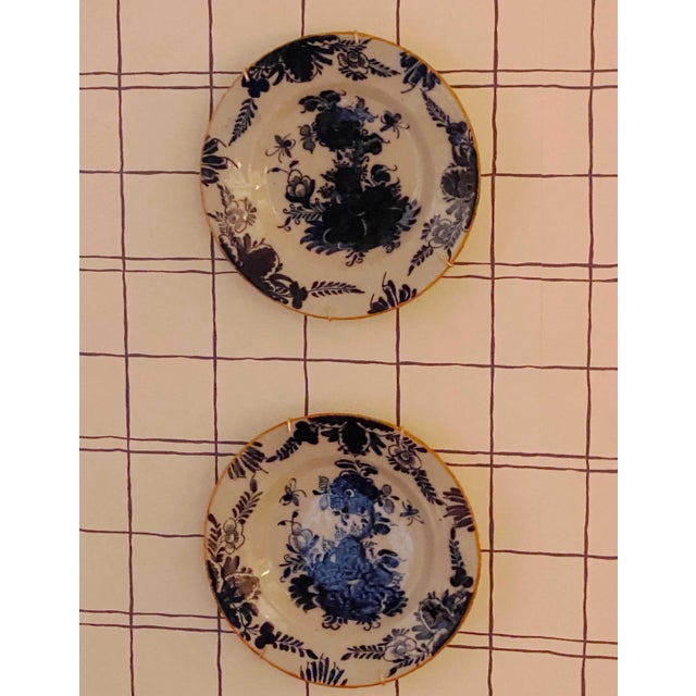 A pair of 18th century delft plates with makers marks.