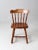 This is a vintage spindle back dining chair. The pub style chair is solid wood with turned splay legs, spindle back, and...