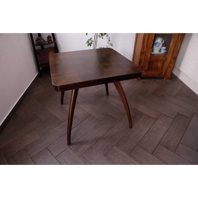 Square retro coffee table designed by Jindřich Halabala in Czechoslovakia, 1960s. The table features a veneered top with...