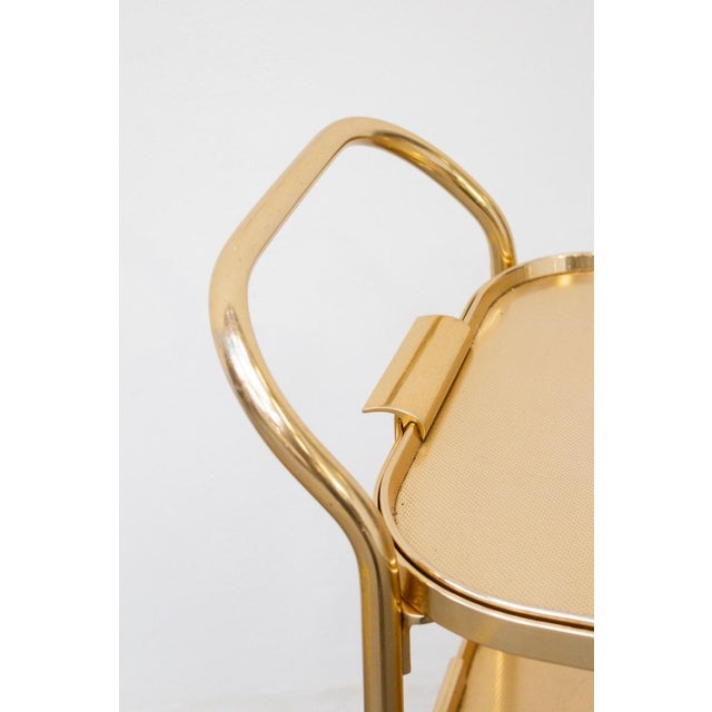 An elegant original kaymet (london) bar trolley, 1950s/1960s. crafted from gold-plated anodized aluminum, this iconic...