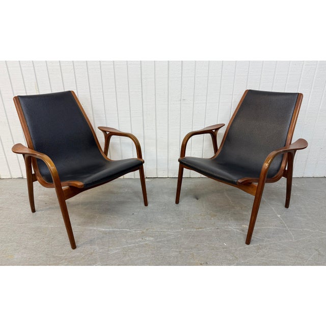 This listing is for a pair of Mid-Century Swedish Modern Lamino Walnut Lounge Chairs. Featuring a curved bent wood design,...