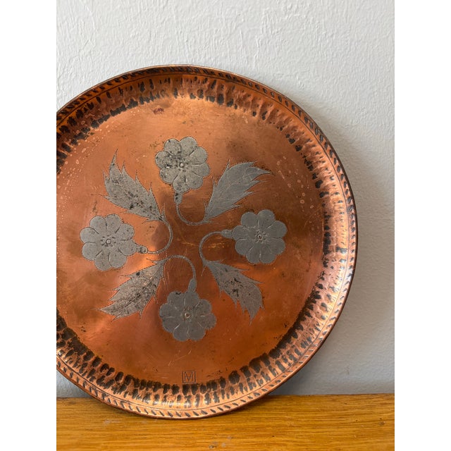 Small in scale but rich in presence, this vintage English hand-hammered copper and pewter tray captures the quiet beauty...
