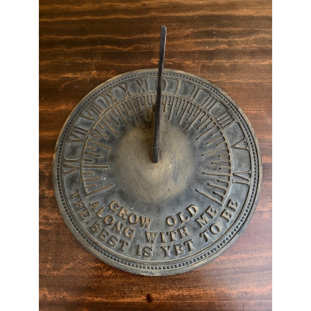 A stunning vintage iron verdigris garden sundial reading "Grow old along with me. The best is yet to be." Late 20th...