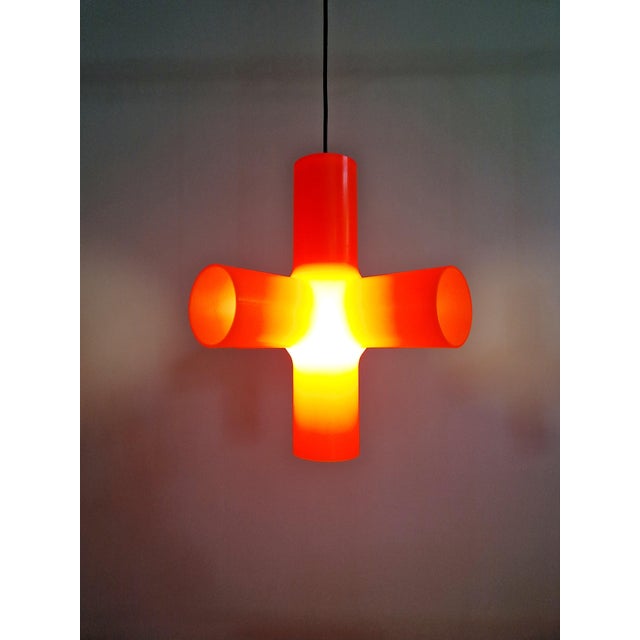 Orange polyethylene "crosslight" pendant light designed in 2001 by dutch designers jan melis and ben oostrum for the...