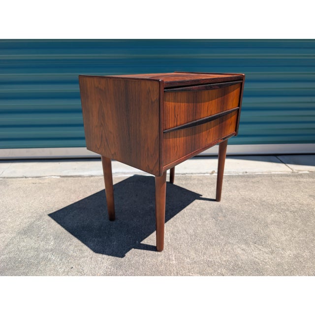 Vintage Danish Mid-Century Modern nightstand or small cabinet crafted from Rosewood with elegant sculpted drawer pulls and...