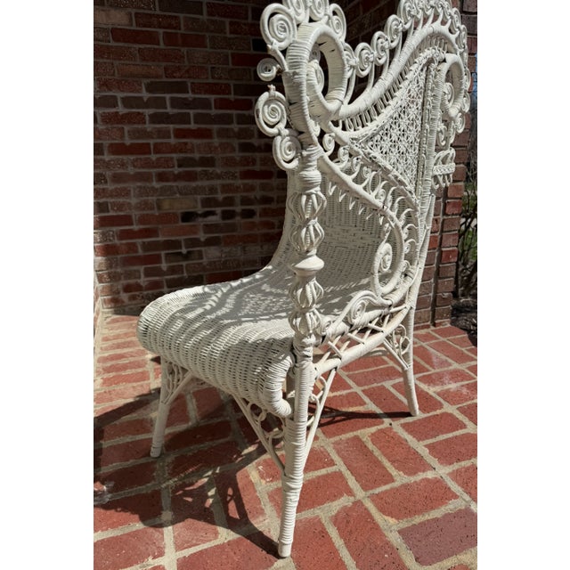 Ornate American Victorian wicker chair, circa 1890. Hand woven and finished in white, this highly decorative chair...