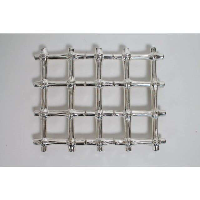 Pair of vintage faux bamboo silver plated expandable trivets. Made in Italy. Expands to 12.25"L. Minor age wear.