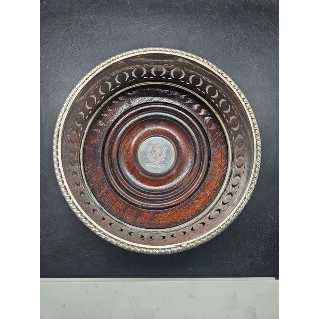 Antique Silver Plate and Wood Wine Bottle Coaster with a Phoenix embossed in Silver.
