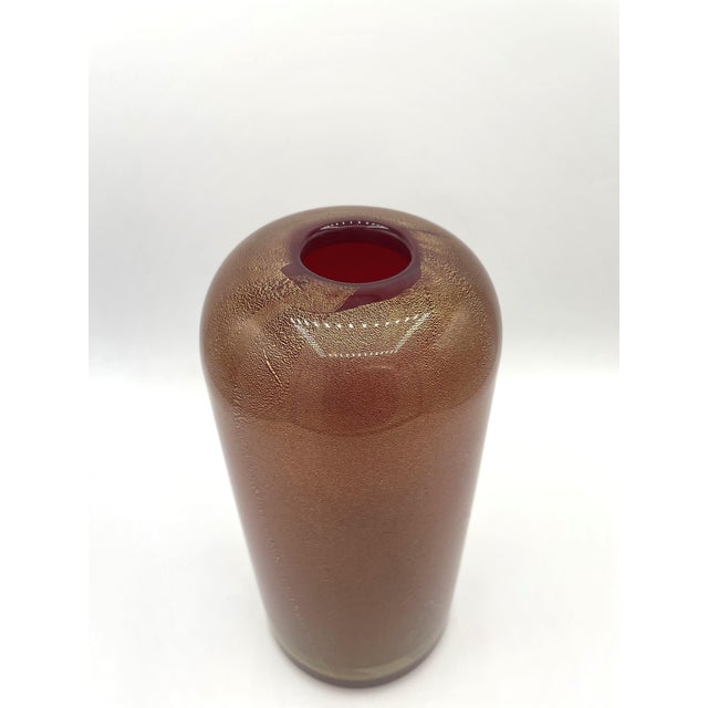 Vase from the "Sommersi oro" series created by Laura Diaz De Santillana for Venini. The vase is orange with gold leaf and...