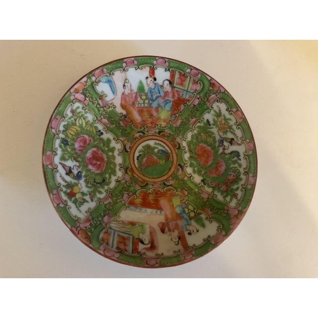 Vibrant hand‑painted Qing Dynasty Rose Medallion plate featuring alternating figural court scenes and floral panels with...