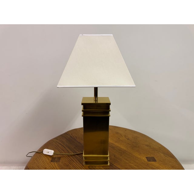 A refined brass table lamp by Vereinigte Werkstätten, exemplifying the restrained elegance and architectural clarity...