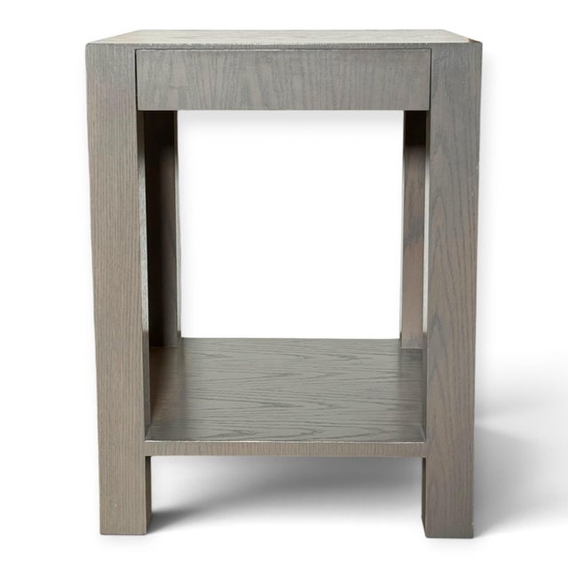 A pair of bedside side tables or nightstands. Parsons-style, each with a single drawer and lower shelf. Solid wood with a...