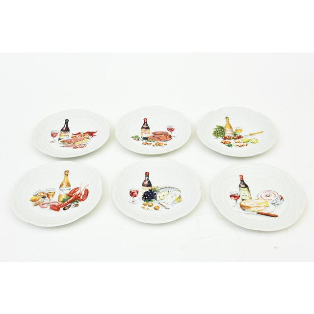 This set of charming French vintage porcelain appetizer or canape plates are all hand painted of varying subject matters...