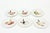 This set of charming French vintage porcelain appetizer or canape plates are all hand painted of varying subject matters...