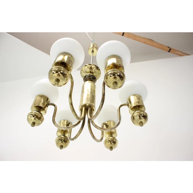 This is a chandelier made in czechoslovakia. It is made of glass, milk glass, and brass. The chandelier was completely...