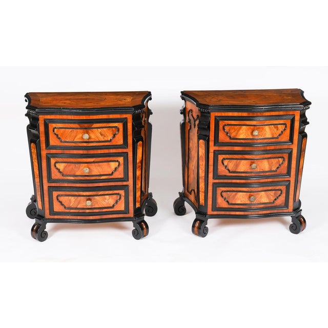 This is an elegant antique pair of Italian, Lombardy Milanese Ferrarese walnut, burr walnut and ebonized commodes, or...